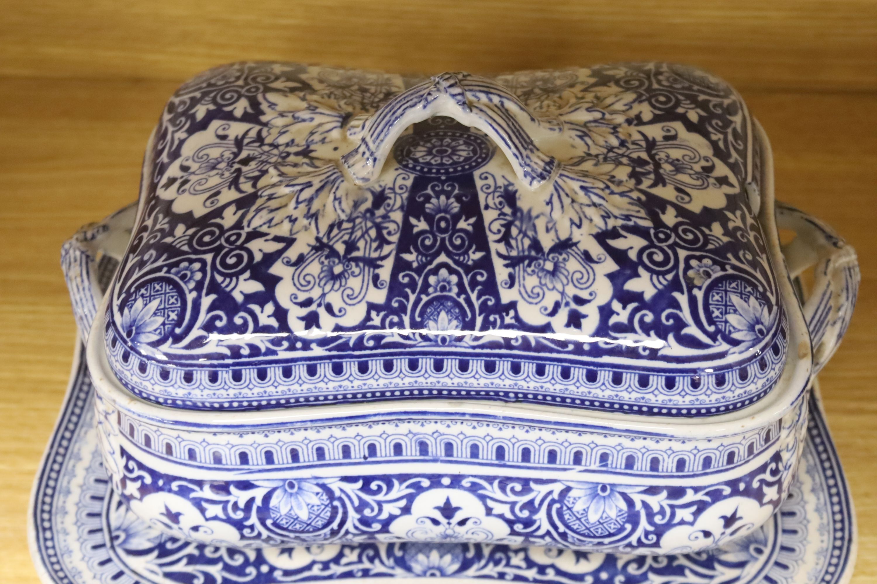 A blue and white meat dish decorated with a Chinese landscape pattern, and a Victorian blue and white tureen, cover and stand, height 17cm